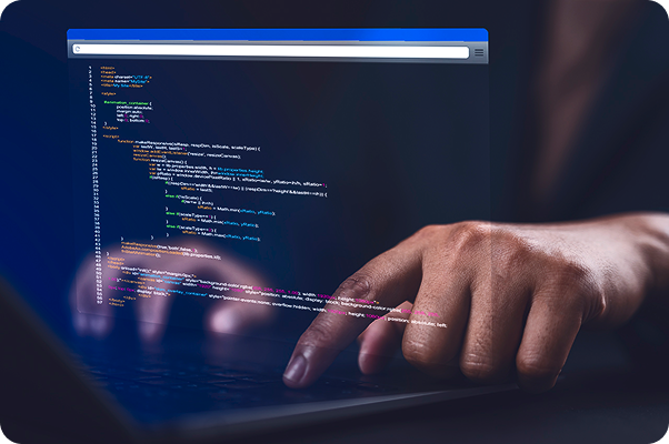 person typing on laptop showing lines of innovative code