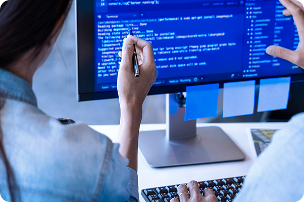 person pointing to code on a computer screen